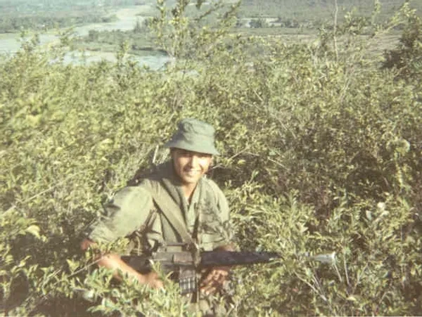 Combat Medic Martinez on patrol in rice paddies