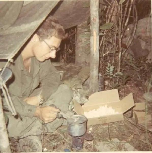 Soldier in hooch making popcorn using C4 for heat
